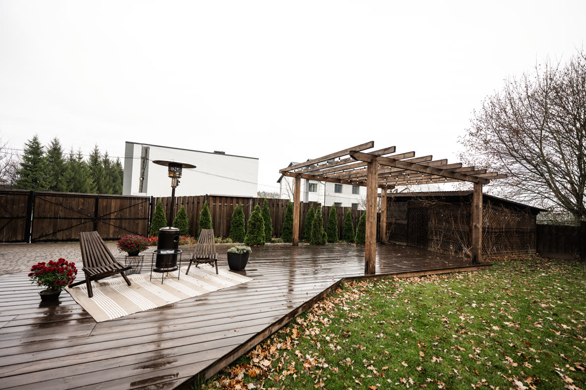 Paved patio with timber decking beside a planted garden