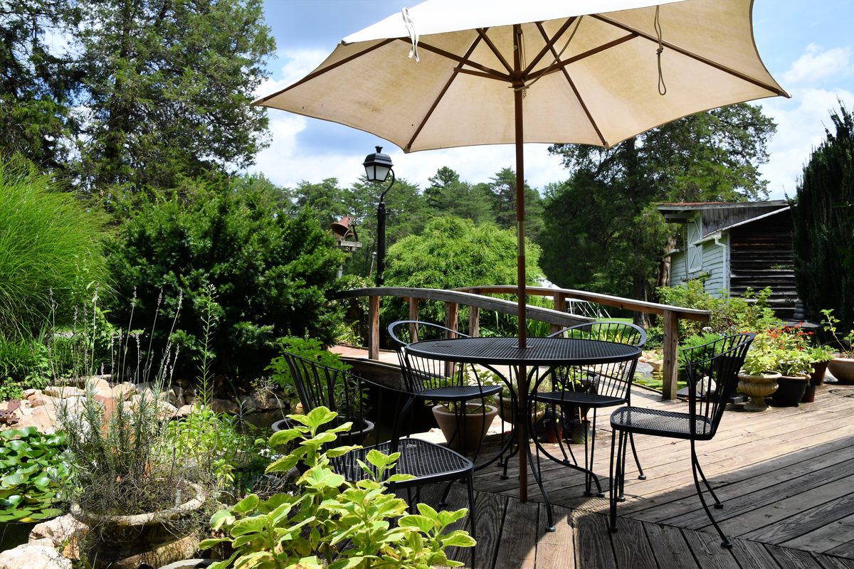 Outdoor table and chairs set out on a wood deck
