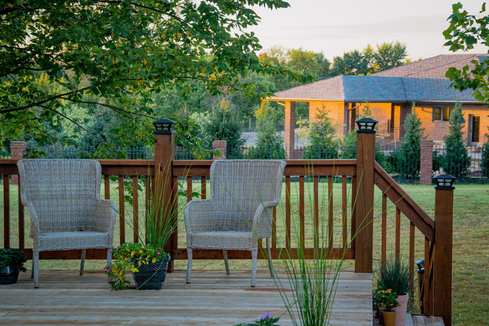 Wicker chairs on a timber deck in evening light